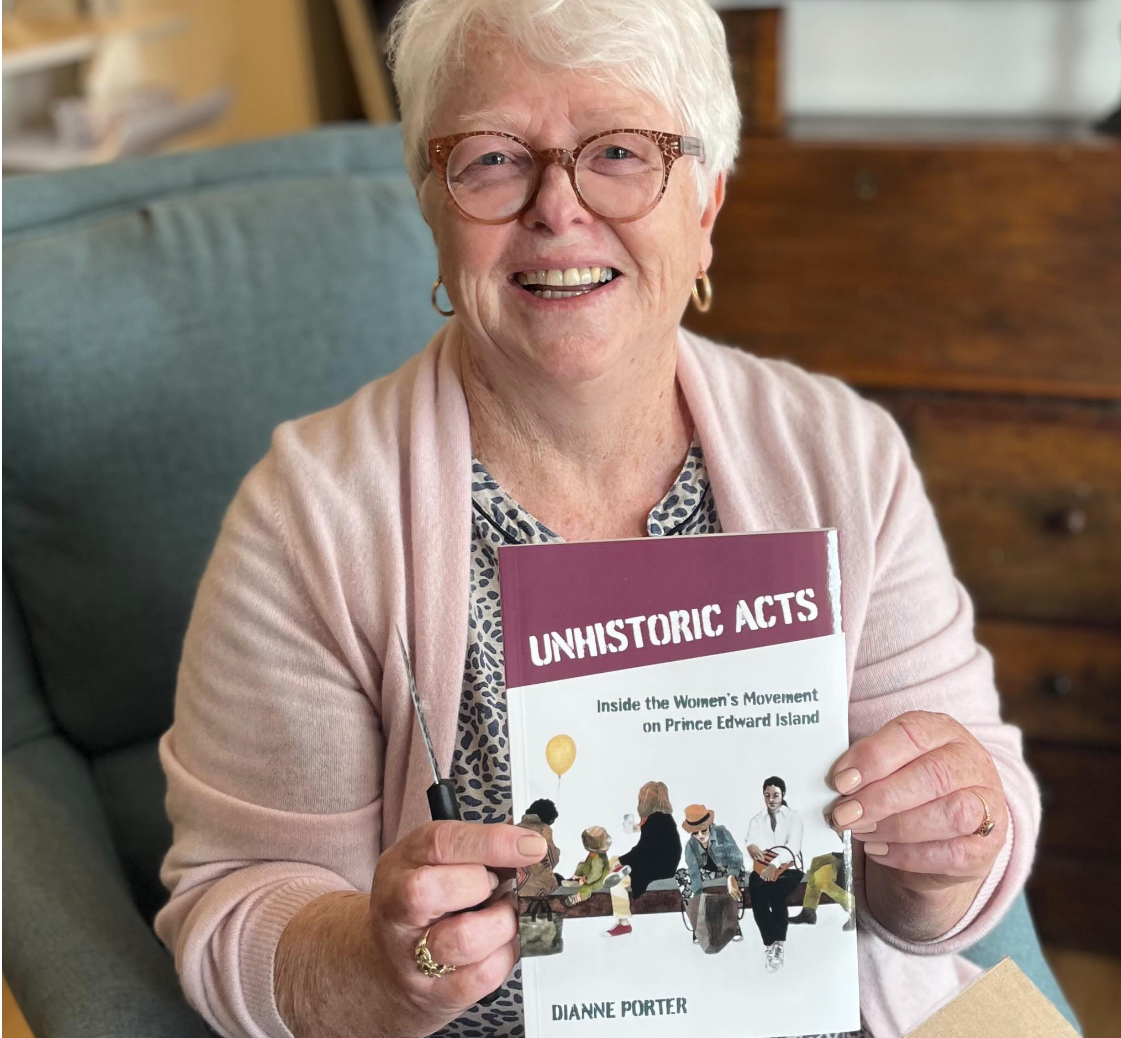 Past Chairperson Dianne Porter holding her book, Unhistoric Acts.