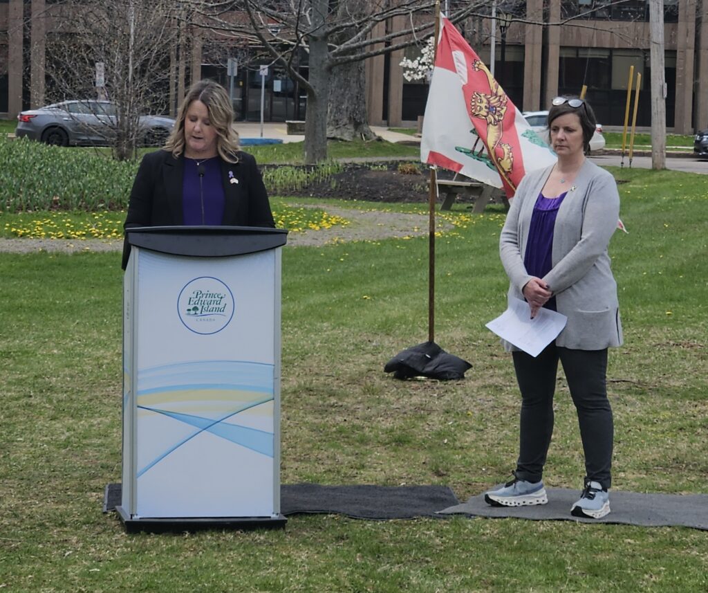 Hon. Jenn Redmond, Minister Responsible for the Status of Women, and Danya O'Malley, Chairperson of the Premier's Action Committee on Family Violence Prevention, speak before the Walk in Silence for Victims of Family Violence in Charlottetown, May 2025.