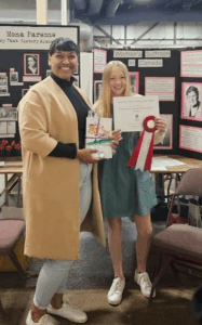 Alexia Riche presents a special prize from the PEI Advisory Council on the Status of Women to a youth at the 2025 Provincial Heritage Fair