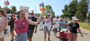 Sarah holding a Pride flag